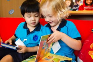 A picture of ESF kindergarten students reading a book